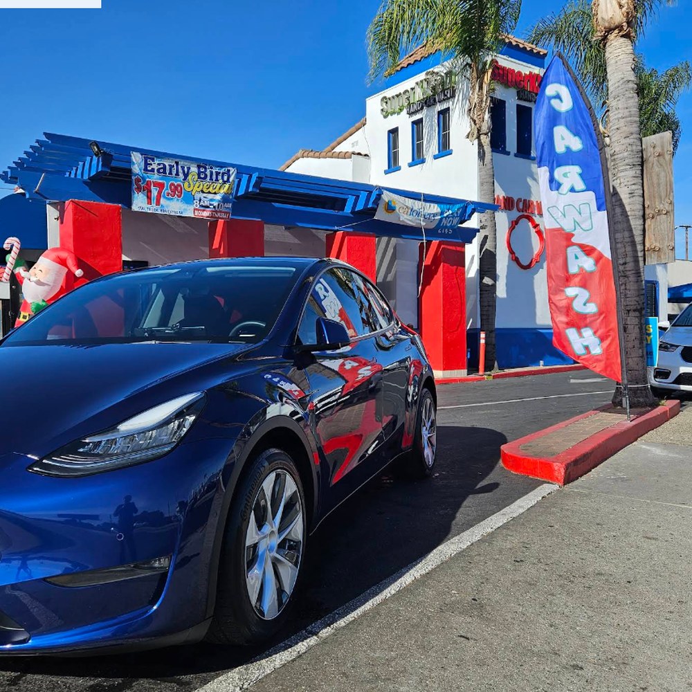 Blue Tesla Model Y freshly cleaned at SuperKleen storefront