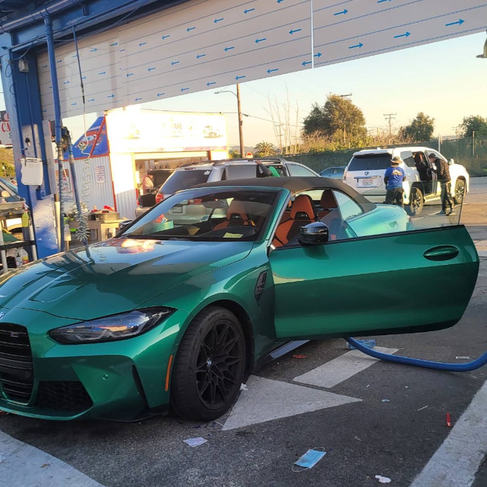 Green BMW M4 Convertible getting hand washed at SuperKleen Car Wash
